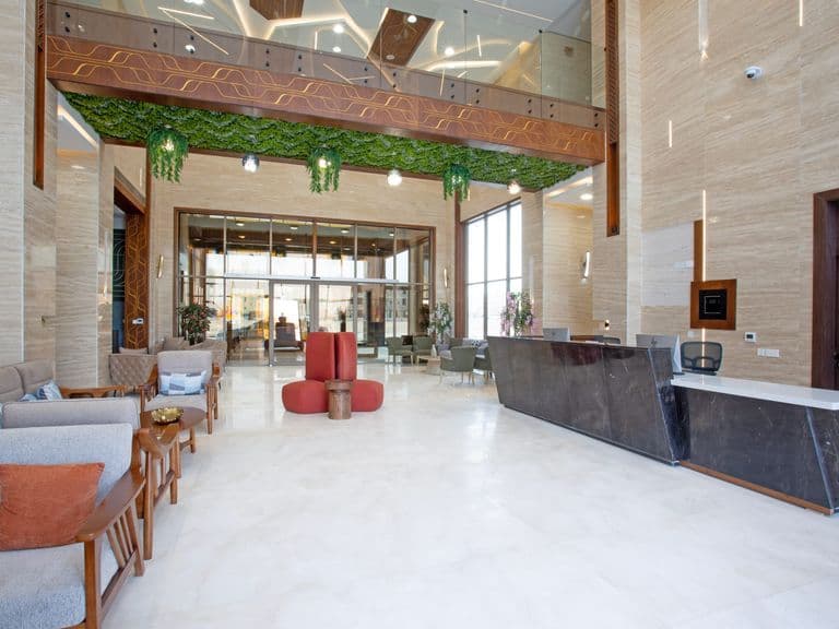 The grand lobby, with its living green ceiling feature and lounge seating