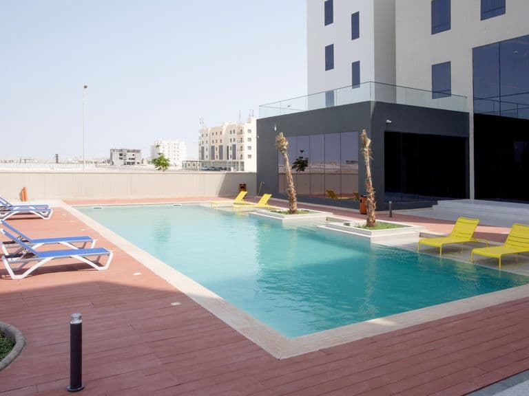The main swimming pool with sun loungers on the terrace