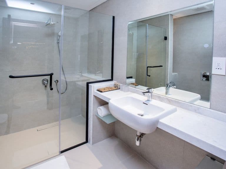 A bathroom with a walk-in shower