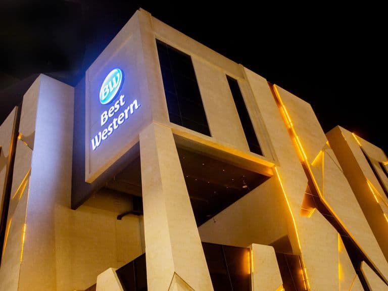 The Best Western sign lit against the night sky