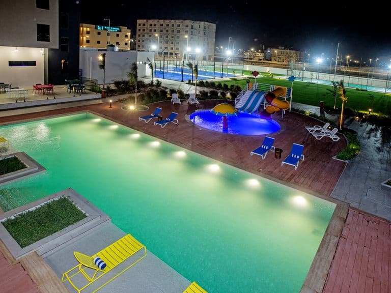 The swimming pool lit at dusk