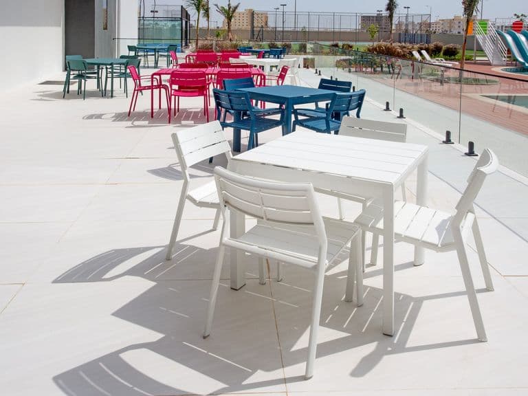 Outdoor terrace seating beside the pool
