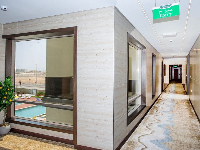 A corridor with a window onto the pool