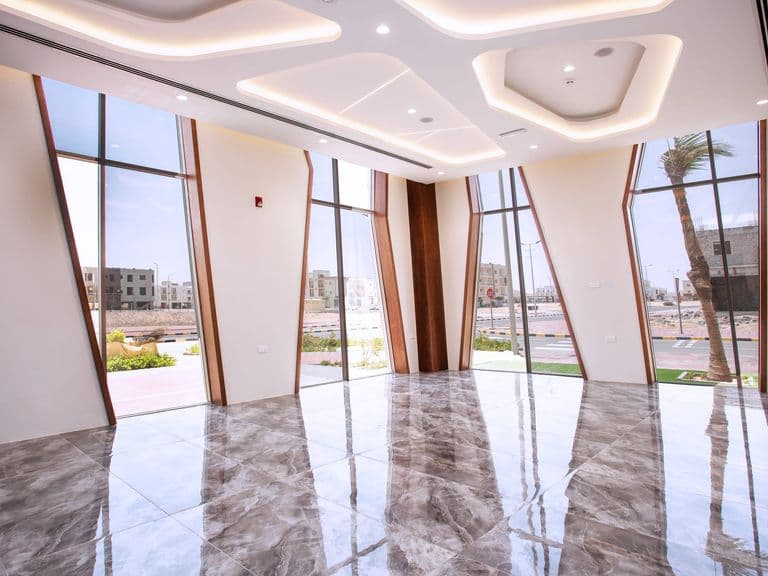 A naturally lit hall with floor-to-ceiling windows