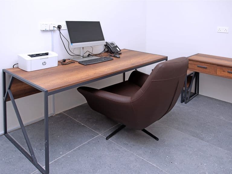 A workstation with computer, printer and telephone